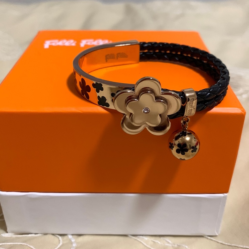 Bracelet - half gold colour with black flowers and half black braided leather